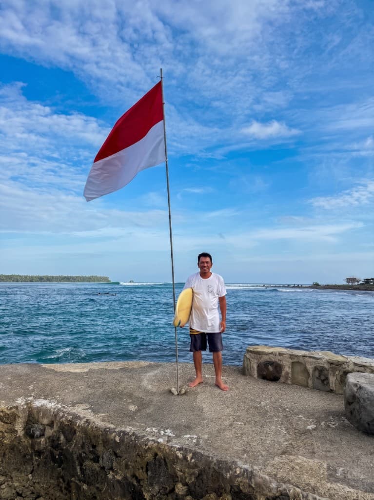 Marinus Hulu, founder of Hulu Surf, with a board at Lagundri Bay